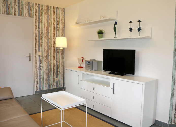 Sideboard mit TV im Wohnzimmer, offener Zugang zur Küche